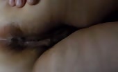 Fat woman using a white vibrator to masturbate