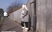 Sexy blonde babe peeing on the alley