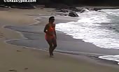 Sexy babe peeing at the beach