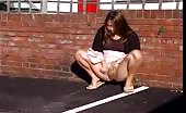 Beautiful teen peeing in parking lot