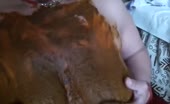 Dark haired babe smears shit on nude body