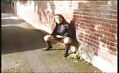 Brown haired babe peeing