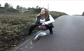 She's peeing on the sidewalk