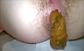 Girl shitting a big brown turd onto a napkin
