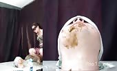Feeding her male slave with a lot of shit