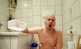 Eating a long turd while stroking his cock