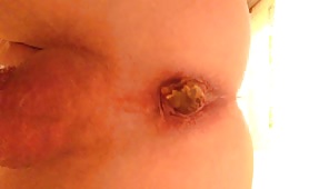 Man shitting out a big brown turd on camera
