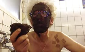 Skinny old man smearing poop on his entire face