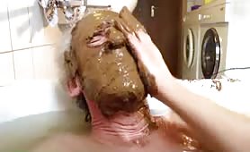 Old man rubbing poop on his entire face