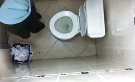 Brunette teen caught peeing in a public bathroom
