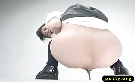 Japanese school girl pooping on a white floor