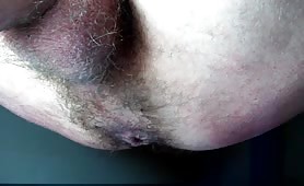 Man shitting a long green turd on the floor