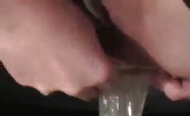 Sexy woman shitting and peeing in a condom