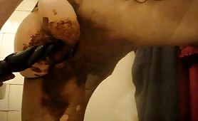 Metallic dildo in his ass