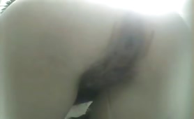 Hairy girl in a public bathroom