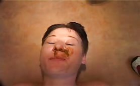 Shitting in her opened mouth