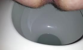 Hairy guy shitting a red one