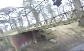 Teen boy shitting diarrhea on a bridge outdoors