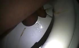 Mature man shitting in toilet at night