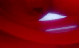 Girl shitting in red toilet bowl close-up