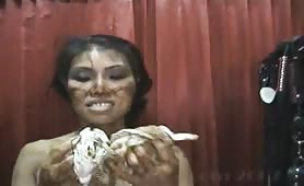 Asian woman smearing shit all over her body with a man