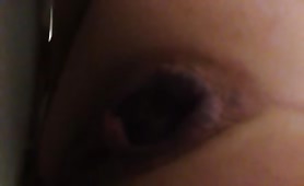 Girl shitting on camera, turd hanging out
