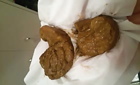 Girl's big fresh turd on a napkin after shitting