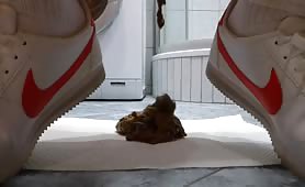Man shitting a small turd on a white napkin