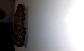 Man eating his own shit off a white surface