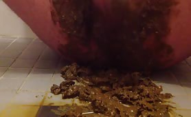 Man pissing while covered in shit on tiled floor