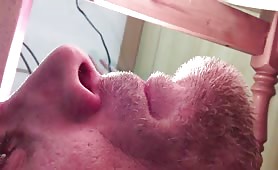 Man shitting on floor under table, close up of turd and asshole