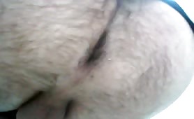 Man shitting in public toilet, turd drops slow
