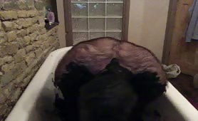Man smearing shit all over his body in bathtub