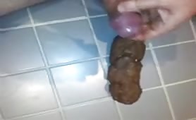 Man holding purple onion over long brown turd on tile