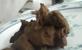 Mature man tasting fresh shit on a plate