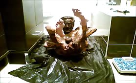 Man smears fresh shit all over his body on bathroom floor