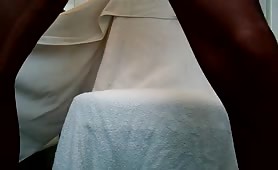 Man in thong shitting on towel with hands on ass