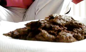 Mature man eating his own fresh shit off a white plate
