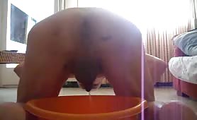 Poop in an orange bucket