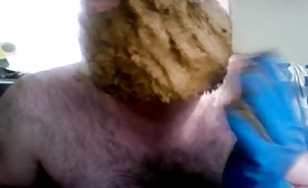 Mature man smearing fresh shit on his face with gloves