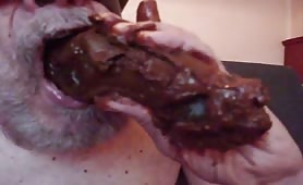 Blindfolded old man sucking a big brown turd