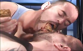Two men kissing with shit in mouth