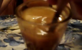 Man stirs scat cocktail in a glass with a spoon