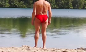 Man in thong shitting by the lake