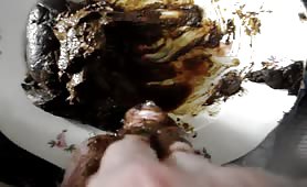 Man smearing shit on his dick over a plate