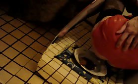 Man in latex shitting on a plate on tiled floor