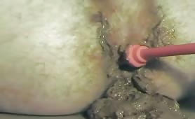 Man shitting while a red toy spins in his ass