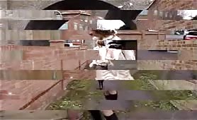 Woman pissing outdoors in coat and boots