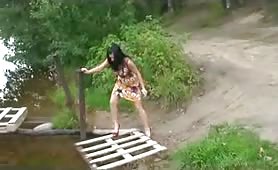 Woman pissing outdoors in heels and dress