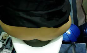 Blonde concentrates while shitting